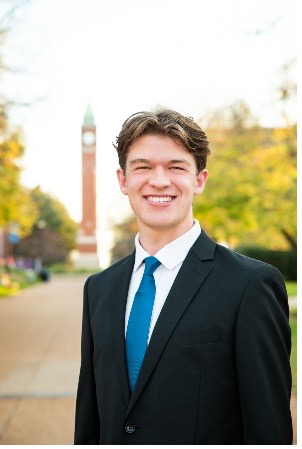 Patrick Bausch stands in front of the SLU clock tower