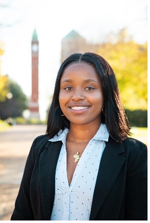 Sally Gacheru stands in front of the SLU clock tower