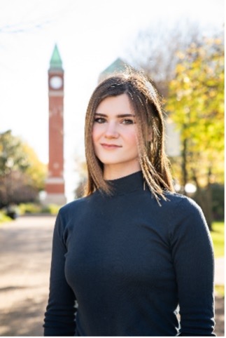 Jacqueline Short stands in front of the SLU clock tower