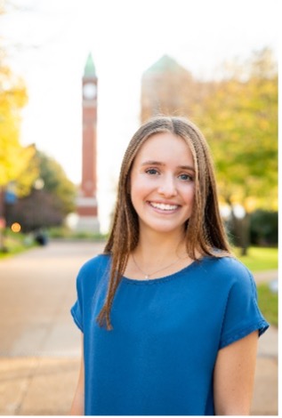 Meredith Vieson stands in front of the SLU clock tower