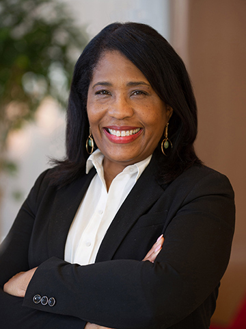 Headshot of Rochelle Smith, smiling while wearing a black blazer and white blouse.