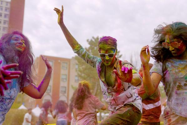 Chalk covered students celebrating Holi 2023 on the quad