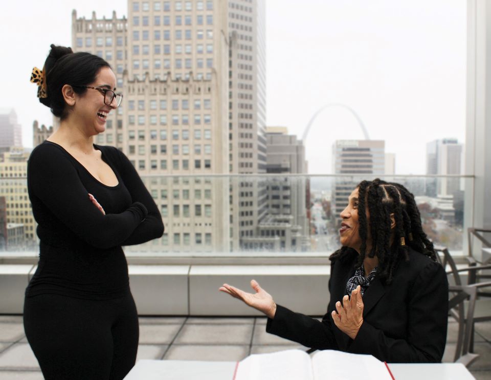 Professor Marsha Griggs talks with a student on the pavilion at Scott Hall