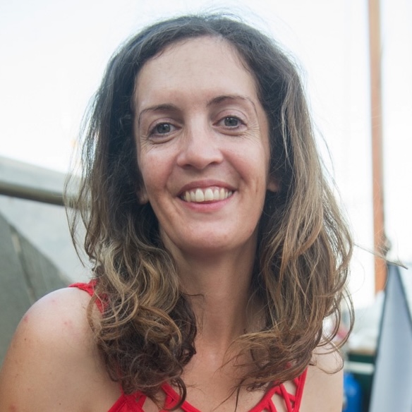 A photograph of artist Mary Mattingly from the shoulders up, smiling 