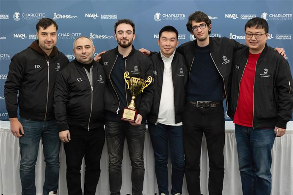 A group of men posing for a photo with a trophy.