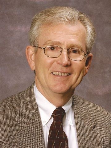 a man smiles at the camera