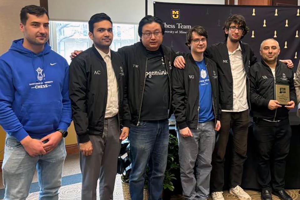 a group of men pose for a picture