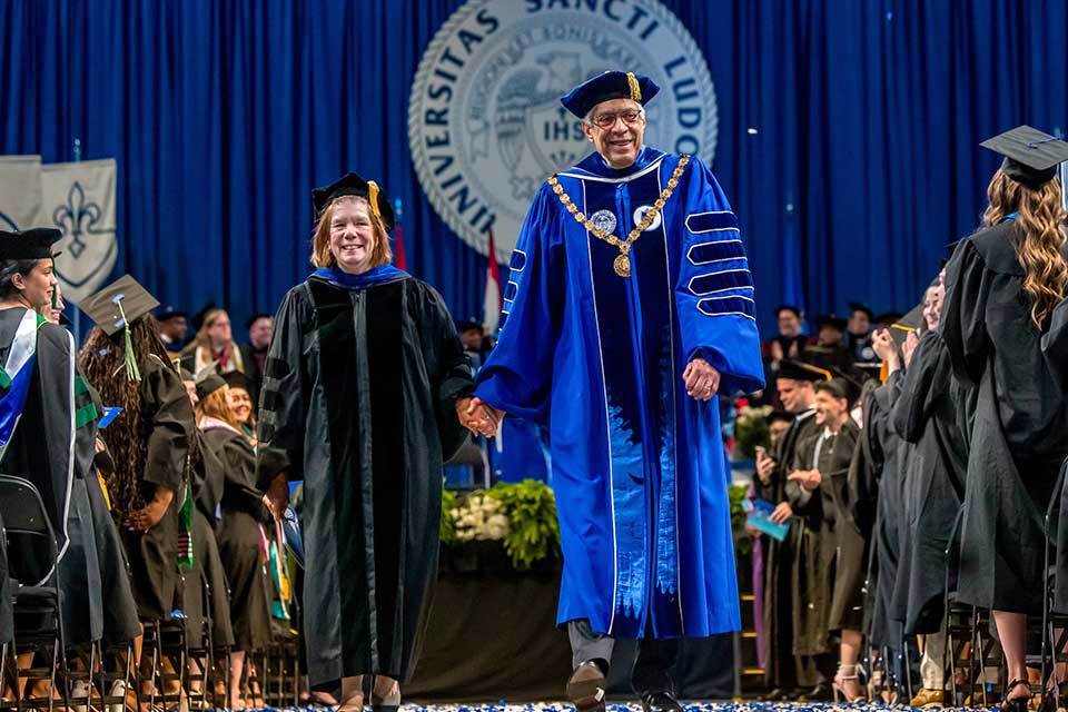 President Fred P. Pestello, Ph.D., and First Lady Fran Pestello, Ph.D., exit Commencement on May 17, 2025. Photo by Sarah Conroy.