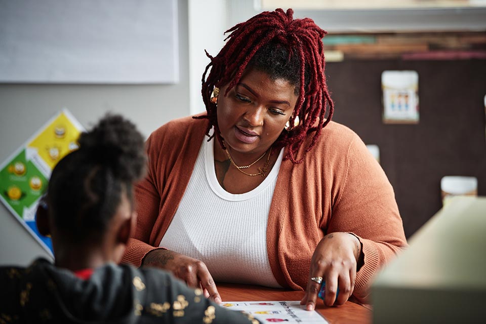 Teacher showing student a document to a student