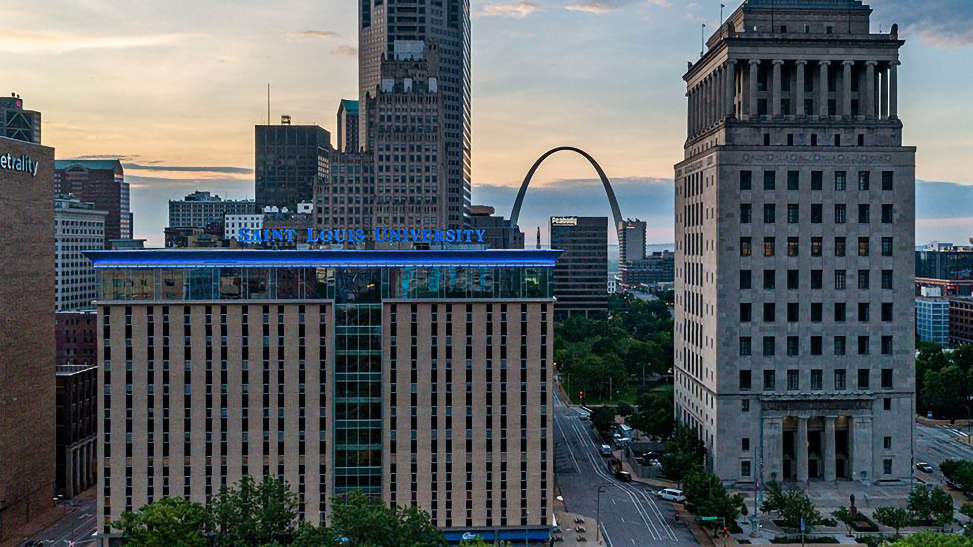 Scott Hall, home to SLU Law, against the skyline of downtown St. Louis, including the Gateway Arch.