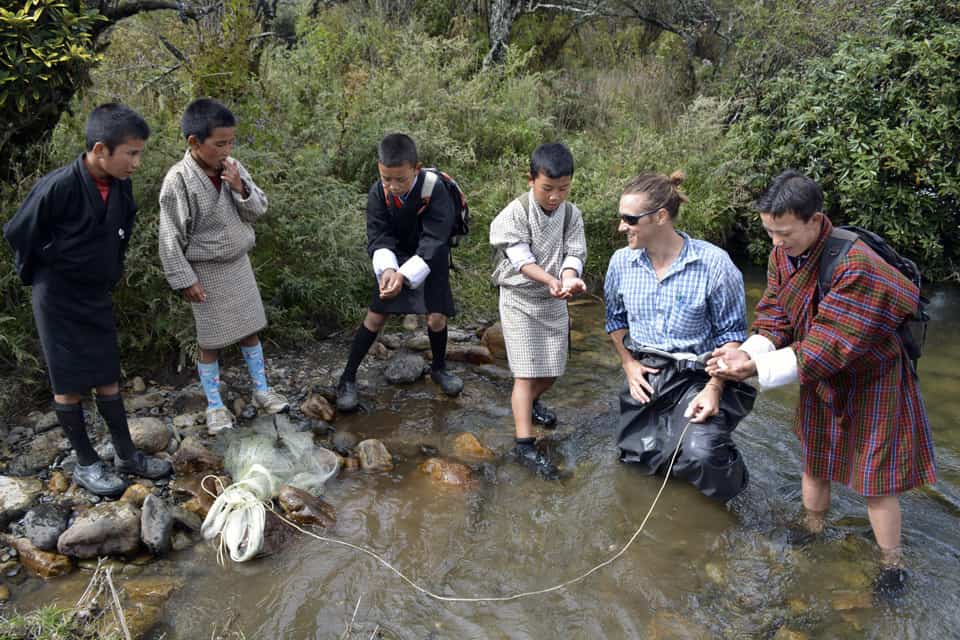 SLU student with children in stream